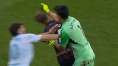 A tense scene of goalkeeper assault during a soccer game in Spain.