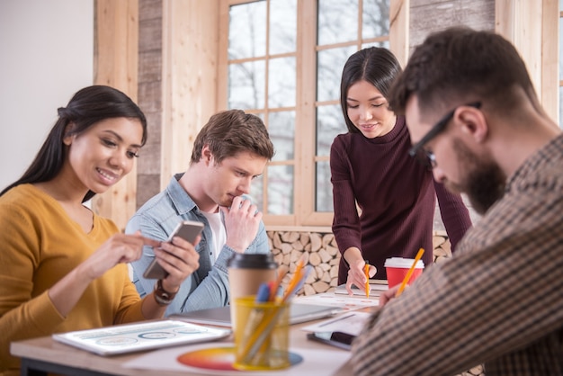 A group discussing Greece social media ban in an office setting.