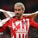 Professional football players celebrating a Champions League victory with Griezmann farewell.