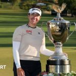 Hannah Green golf victory at a tournament with a beautiful course background.