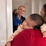 Health visitors discussing caseload management in a professional setting.