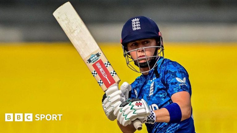 A group of women cricketers showcasing teamwork during a match, focused on the T20 World Cup legacy.