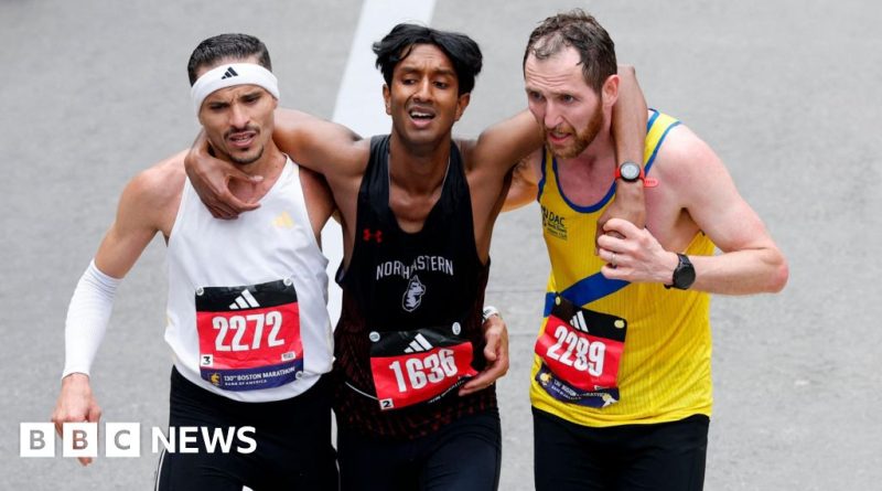 Runners help exhausted man cross marathon finish line, showing teamwork.