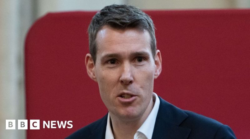 A diverse group in a meeting discussing leasehold reform in professional attire.