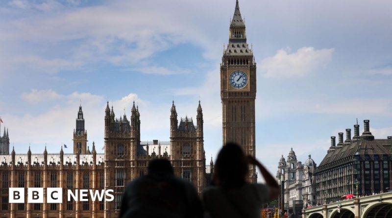 A group of parliament members discussing the Mandelson inquiry vote in formal attire.