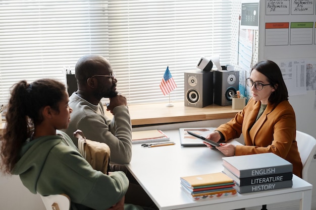 Group of professionals discussing spotting fake news in a modern office.