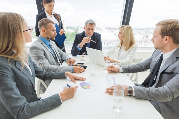 A professional meeting discussing the financial impact of the Iran conflict.