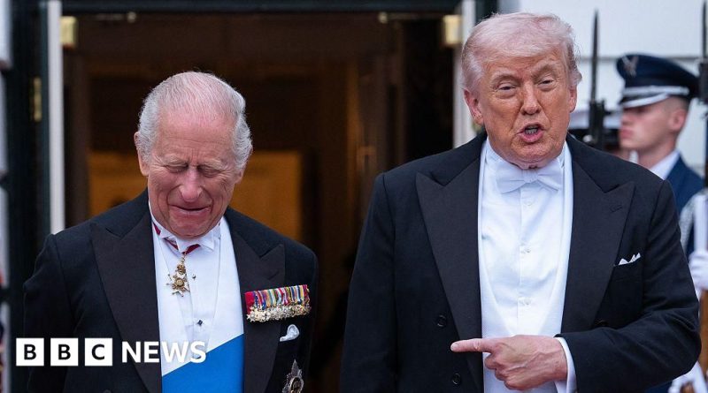 Politicians discussing the King's US visit impact in a banquet hall.