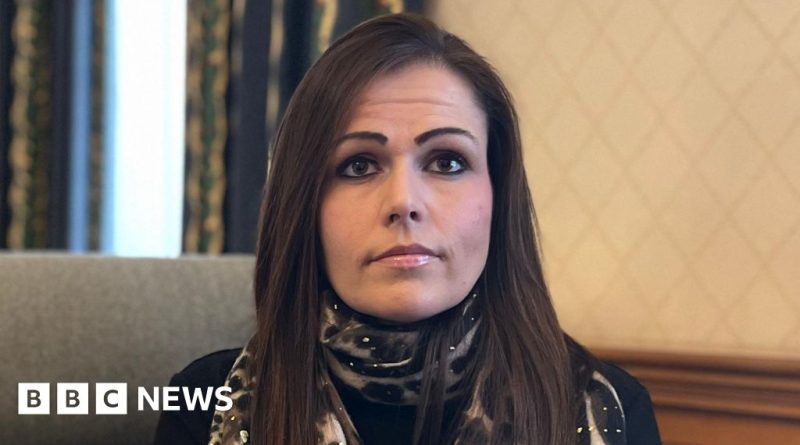 A woman reflecting on the impact of voyeurism in a living room.