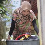 Group of domestic workers discussing their rights in a professional setting.