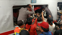 Emergency responders assist victims at the Indonesia train crash site.