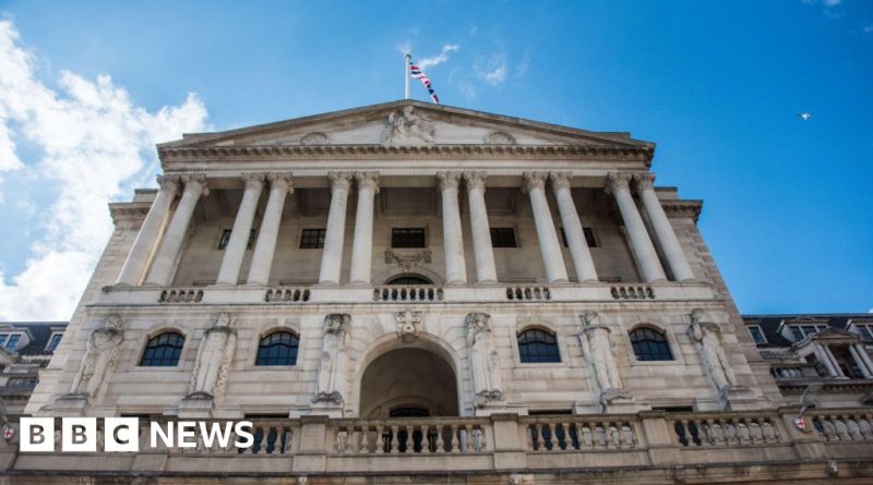 A group of financial analysts discussing interest rates amid the Iran conflict.