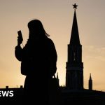 Group of professionals discussing Russia internet restrictions in office setting.