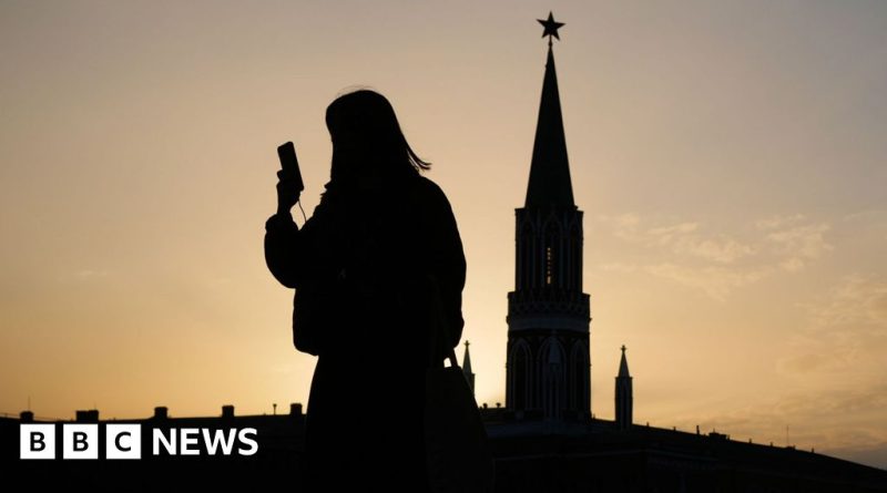 Group of professionals discussing Russia internet restrictions in office setting.