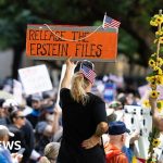 Professionals in a meeting discussing the Epstein file release investigation.