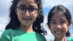 Professionals discussing the schoolgirl crash investigation in a somber setting.