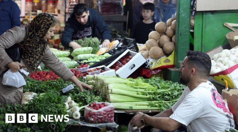 Professional workers discussing Iran job losses in a tense office setting.