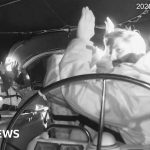 Professionals discussing humanitarian aid on a boat in the sea.