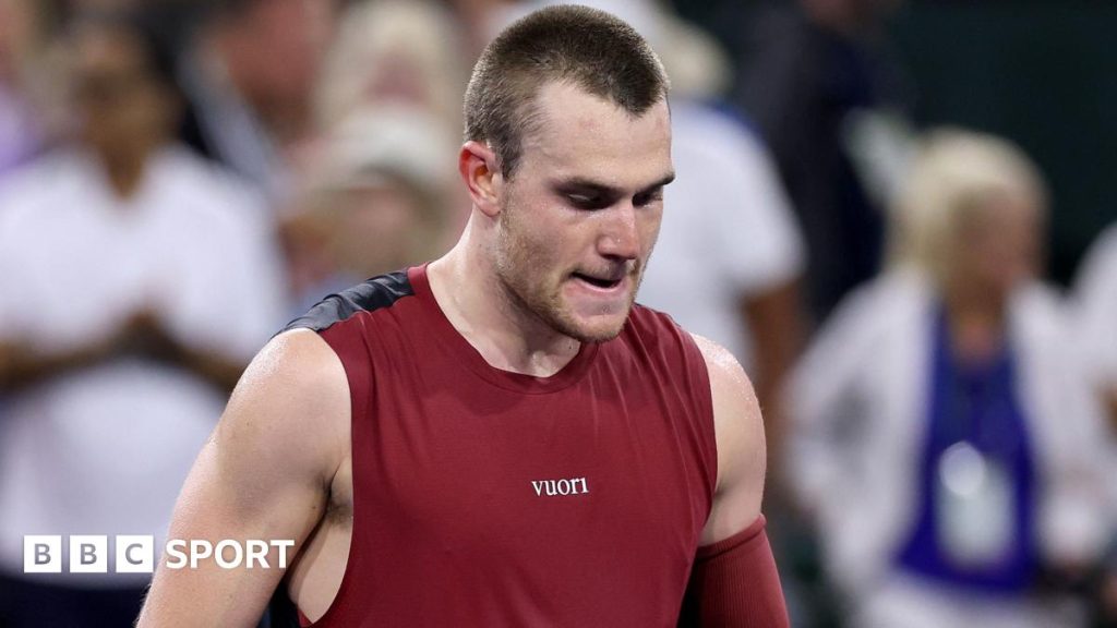 Young male tennis player with a knee injury, focusing on recovery.