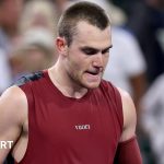 Young male tennis player with a knee injury, focusing on recovery.