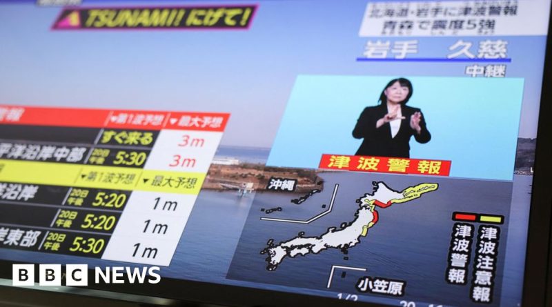 Professionals discussing Japan earthquake alert and safety plans in a meeting.