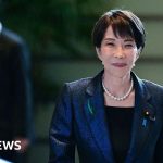 Professionals discussing Japan arms export rules in a meeting.