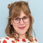 A busy market displaying colorful hair accessories, showcasing a hair accessories business success.