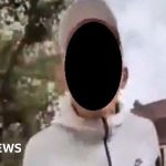 A diverse group of people in professional attire discussing antisemitic attack awareness.