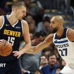 Nuggets playoff hopes highlighted by basketball action scene.