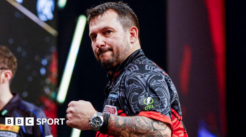 Jonny Clayton competing in a darts match at Rotterdam, showcasing his skills.