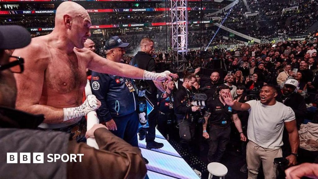 Promoters discussing the Joshua Fury fight in a professional setting.