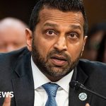 A business meeting discussing the Kash Patel lawsuit against The Atlantic.