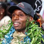 Crowd celebrating Sabastian Sawe's marathon victory at the airport.