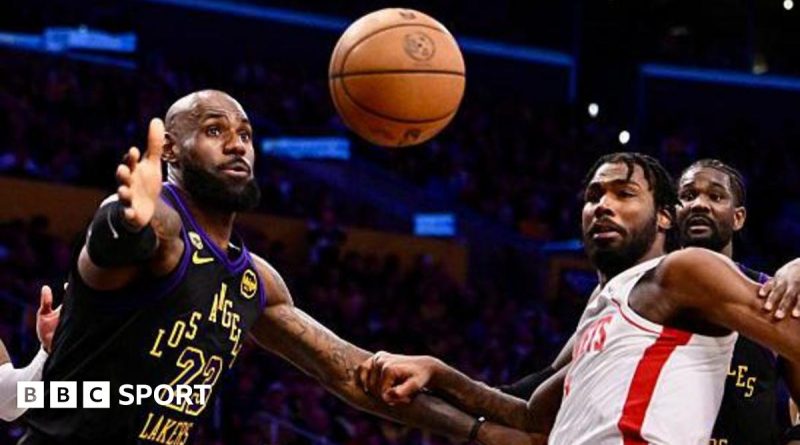 Basketball players in professional attire during a game, illustrating Lakers series lead.