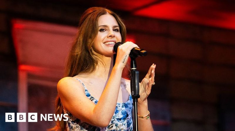 Professionals in business attire discussing the new Lana Del Rey Bond theme.