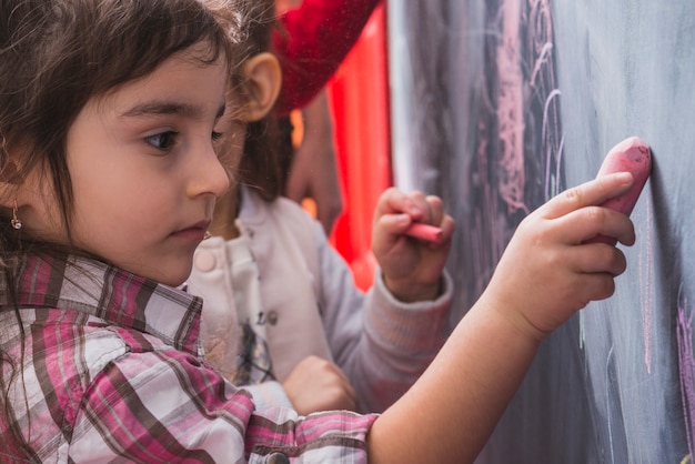 A classroom scene showing children in art therapy, addressing the impact of war on Iranian children.