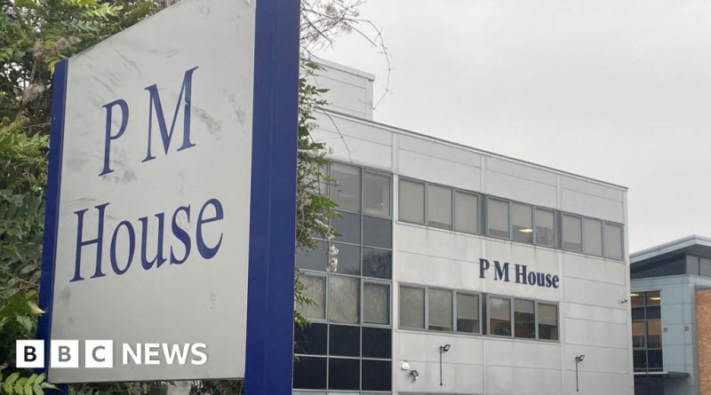 Professionals discussing serious issues related to a fraud investigation in a modern office.