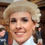 A professional barrister showing determination in her legal career journey.