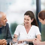 A diverse group discussing Liberal Democrats social care funding plans.