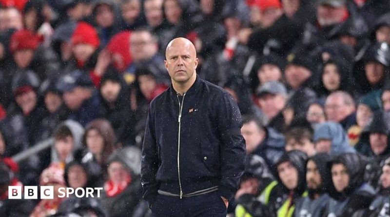 Professionals discussing Liverpool's Champions League performance in a meeting.