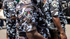 Police officers working together during a rescue operation for the local king kidnapped in Nigeria.