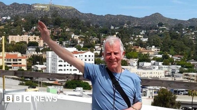 Man exploring Frank Sinatra music legacy in a museum setting.