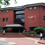 Courtroom scene depicting professionals discussing evidence related to the rape of Sikh woman.
