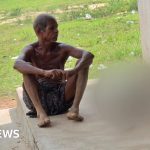A man carries his sister's skeleton in a bank to prove her death.
