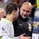 Soccer fans celebrating Manchester City league standings at a stadium.