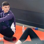 Young Manchester United youngsters training on the soccer field.