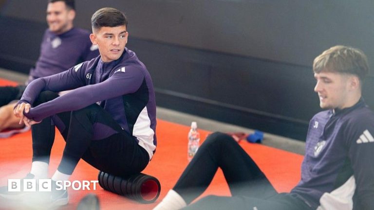 Young Manchester United youngsters training on the soccer field.