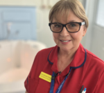 Healthcare professionals discussing safety measures in the maternity unit reopening.