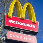 Group of professionals discussing McDonald's abuse allegations in a safe workplace environment.