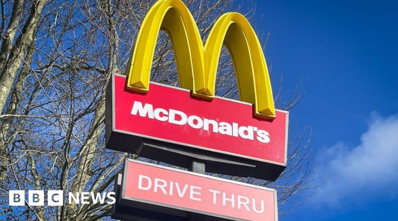 Group of professionals discussing McDonald's abuse allegations in a safe workplace environment.